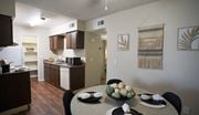 Tucson apartment for rent - A kitchen with a table set for a meal.