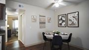 Tucson apartment for rent - A dining room with a table set for two and a painting on the wall.