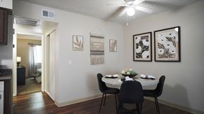Tucson apartment for rent - A dining room with a table set for two and a painting on the wall.