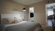Tucson apartment for rent - A bedroom with a large bed and a lamp.
