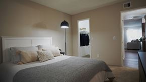 Tucson apartment for rent - A bedroom with a large bed and a lamp.
