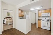 Casa Grande apartment for rent - A white kitchen with wooden cabinets and a white stove top oven.