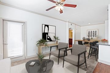 Goodyear apartment for rent - a living room with a dining room table and chairs and a ceiling fan