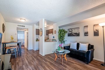 Yuma apartment for rent - A living room with a black couch and a coffee table.