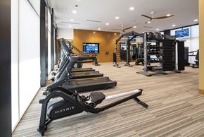 Tucson apartment for rent - a gym with treadmills and other exercise equipment in a room with a window