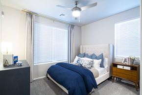 Tucson apartment for rent - a bedroom with a bed and a ceiling fan