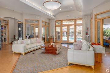 Queen Creek apartment for rent - A living room with a white sofa and a wooden coffee table.