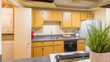 Tucson apartment for rent - a kitchen with wooden cabinets and a counter top