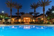 Goodyear apartment for rent - a resort style swimming pool with lounge chairs and umbrellas at night