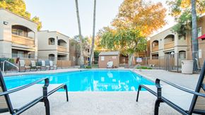 Tucson apartment for rent - Tanglewood pool view with relaxation area and tall trees surrounding