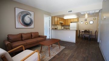 Tucson apartment for rent - A living room with a brown couch and a painting on the wall.