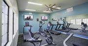 Tucson apartment for rent - A gym with treadmills, exercise bikes, and a television.