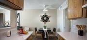 Tucson apartment for rent - A kitchen with a table set for two and a ceiling fan.