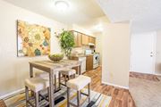 Tucson apartment for rent - A dining area with a table and chairs and a painting on the wall.