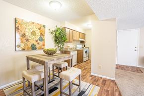 Tucson apartment for rent - A dining area with a table and chairs and a painting on the wall.