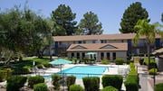 Tucson apartment for rent - A large building with a pool in front of it.