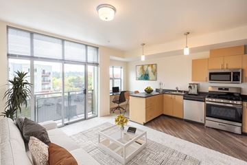Sammamish apartment for rent - a living room with a couch and a coffee table and a kitchen with a sink