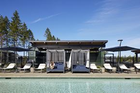 Lacey apartment for rent - a pool with chairs and umbrellas and a canopy above it