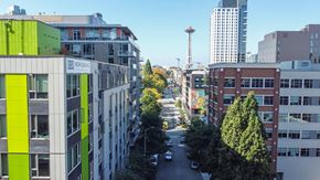 Seattle apartment for rent - a view of a city street with tall buildings and trees