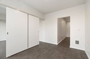 Seattle apartment for rent - a bedroom with white walls and carpet and a closet