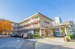 Seattle apartment for rent - an apartment building with cars parked outside of it