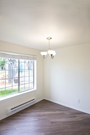 Enumclaw apartment for rent - an empty room with a large window and a chandelier