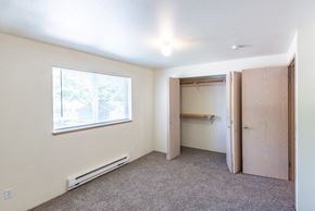 Olympia apartment for rent - a small bedroom with a closet and a window