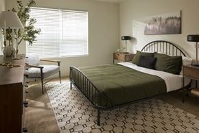 Bremerton apartment for rent - a bedroom with a bed and a chair