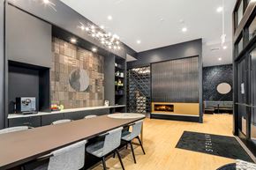 Seattle apartment for rent - a dining room with a long table and chairs and a fireplace