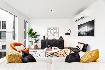 Bellevue apartment for rent - a living room with white walls and a couch and a tv