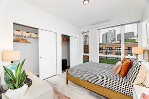Bellevue apartment for rent - a bedroom with a bed and a large window