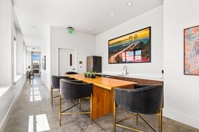 Tacoma apartment for rent - a room with a long wooden table with four chairs and a large painting on the wall