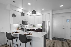 Bend apartment for rent - an open kitchen with white cabinets and a white counter top