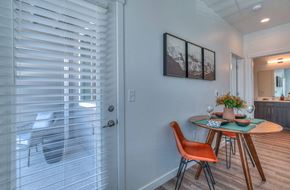 Bend apartment for rent - a dining room with a table and chairs next to a glass door