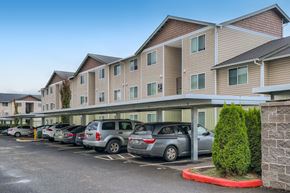 Vancouver apartment for rent - a row of cars parked in front of a building