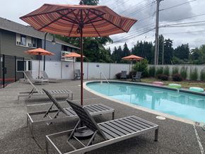 Portland apartment for rent - a pool with umbrellas and chairs next to a pool