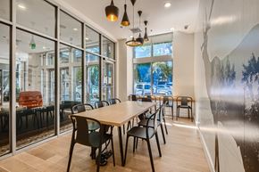 Portland apartment for rent - a long table with chairs in a room with large windows