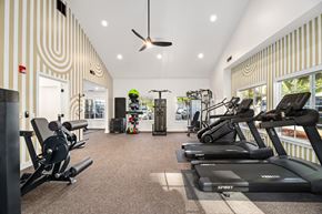 Lacey apartment for rent - A gym with a variety of equipment including treadmills, weights, and a fan.