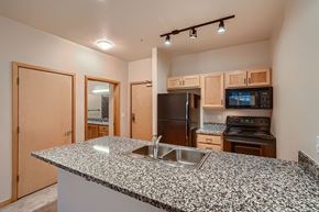 Portland apartment for rent - a kitchen with a granite counter top and a sink