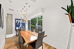 Seattle apartment for rent - a dining room with a wooden table and chairs and a large window
