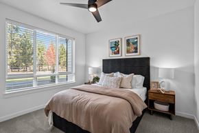 Bend apartment for rent - a bedroom with a large window and a bed