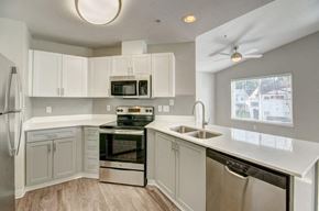 Dupont apartment for rent - Modern Kitchen With Stainless Steel Appliance Suite, Spacious White Cabinetry, and Sleek Counters at Clock Tower Village, Washington, 98327