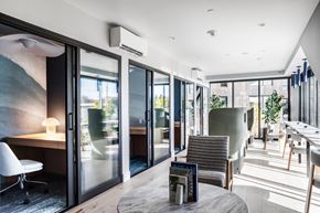 Bellevue apartment for rent - a lounge area with chairs and tables and sliding glass doors