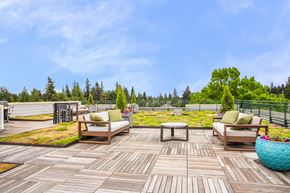 Seattle apartment for rent - a deck with chairs and a table on top of a roof