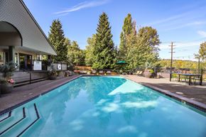 Seattle apartment for rent - A large swimming pool with a building on the left side.