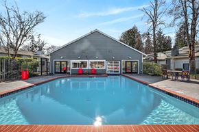 Milton apartment for rent - A swimming pool in front of a grey building.