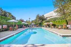 Milton apartment for rent - a swimming pool with chairs and umbrellas next to a resort style pool