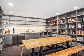 Seattle apartment for rent - a dining room with a wooden table and bookshelves