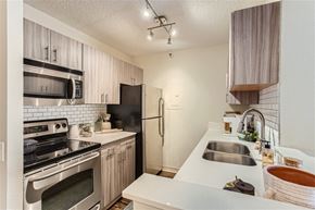 Portland apartment for rent - an updated kitchen with stainless steel appliances and white counter tops