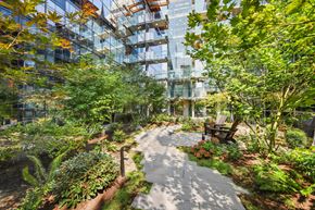 Bellevue apartment for rent - A garden with a winding walkway and a bench.